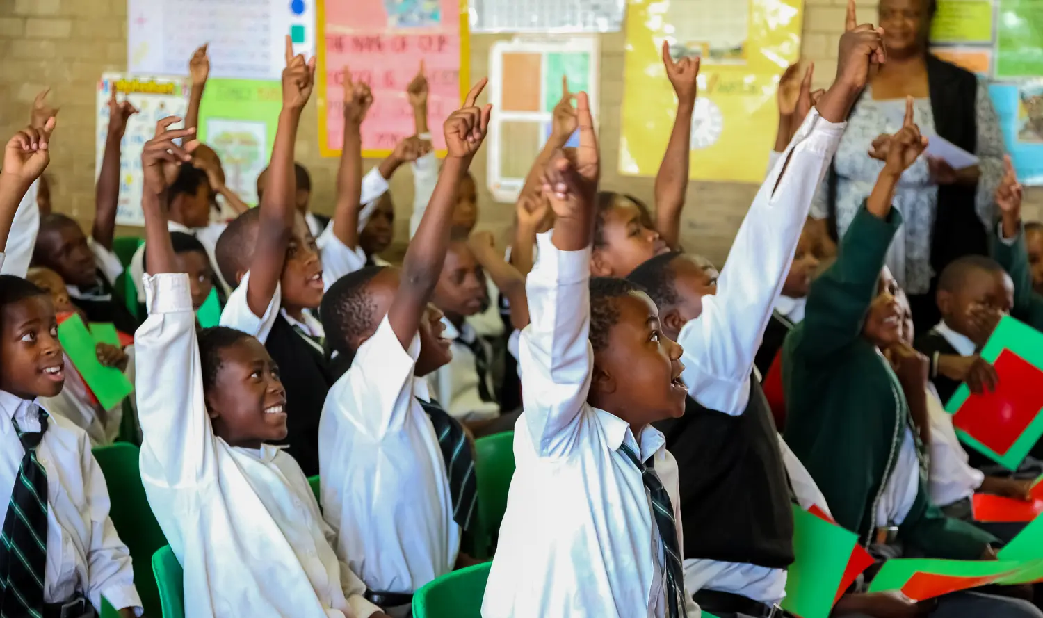 Happy school children smiling together in a classroom